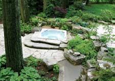 The Canvas:An enchanted forest of cedar and pine, tiny space, tricky accessThe Palette: Flagstone patio, geometric pond, cascading waterfallThe Masterpiece: A secret stone garden, nature’s balm for the weary soul