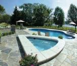 THE CANVAS:A hilly property, yellow colonial-style house, lakeside viewsTHE PALETTE:Classic country motif, contrasting stone and concrete, unusual shapes in waterTHE MASTERPIECE: Unique multi-level patios, marriage of form and function, an inviting outdoor space