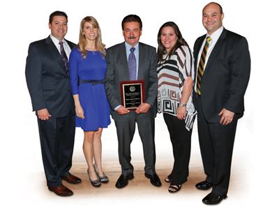 The Sanchez clan: Proudly

displaying a recent award are, l-r, Edgar Sanchez, COO; his wife

Julie; Cesareo Sanchez, president; Karla (Sanchez) Escobar,

director human resources; Al Escobar, sales/marketing

manager.