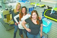 Left to right, Lesa Angleton with two of her daughters, April Harris, center, and Heather Angleton, in the newly opened location for their pool and spa service and retail store Pool Medics Rx in Derby, Kan.