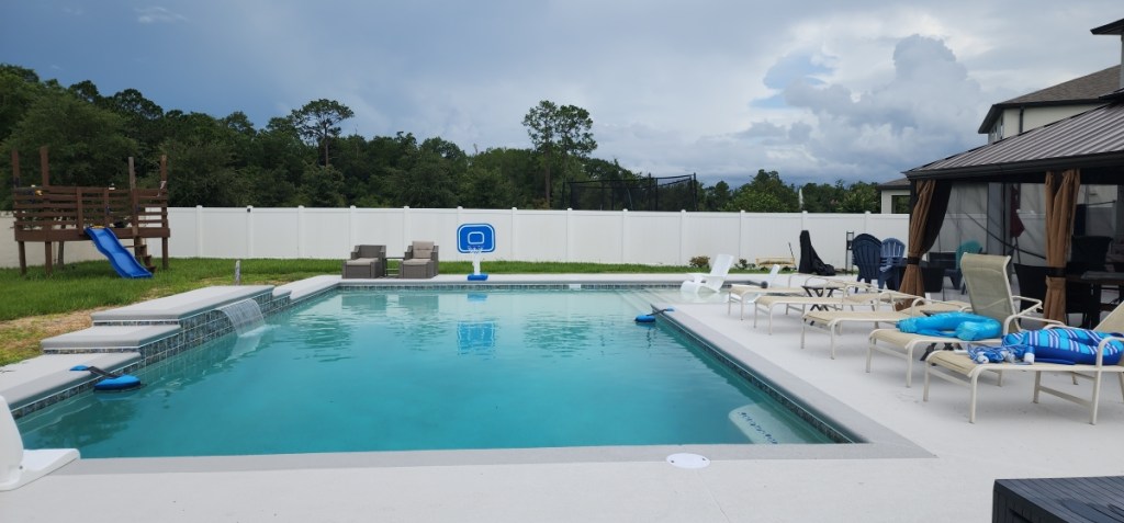 The Mullnix pool surrounded by a large concrete deck