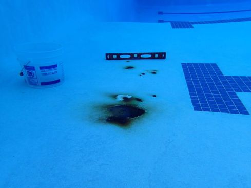 Before: A municipal pool undergoes a rebar repair operation. The rust
 stain shown in the top photo only hints at the extent of damage under 
the shell.