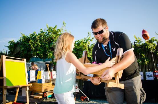 Winner, winner: Galen Hyatt hands out the items won during the event's silent auction.