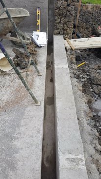 Acrylic vanishing-edge walls are place in a slot.