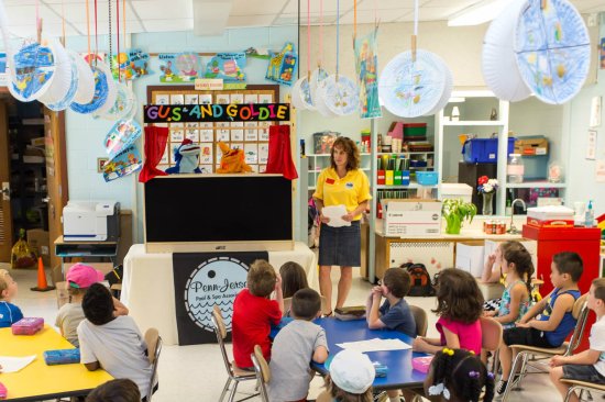 A NESPA representative presents a Gus and Goldie puppet show in 2014.