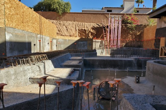 The basement pool in progress. The rock waterfall is being built one terrace at a time.