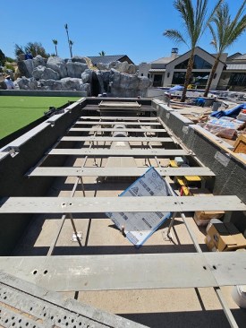 The surf simulator in progress. The inflatable portion will sit atop the slats, with the funnel intake underneath. The notches in the edges of the basin will accommodate rollers for the movable floor. 