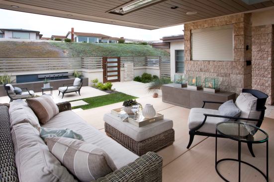 More often than not, TVs are found in the backyard. But with this home's location off the coast of San Diego, glares from the sun made it more applicable to an area facing north, which in this case, was the front yard. When not in use, a retractable cover hides the TV from sight. Above, built-in heating provides warmth during the cool morning and evening breeze.