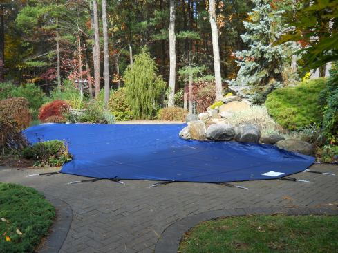This image shows an example of a winterized pool using a safety cover.