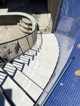 A stairway leading from the main-pool level down to the lower pool.