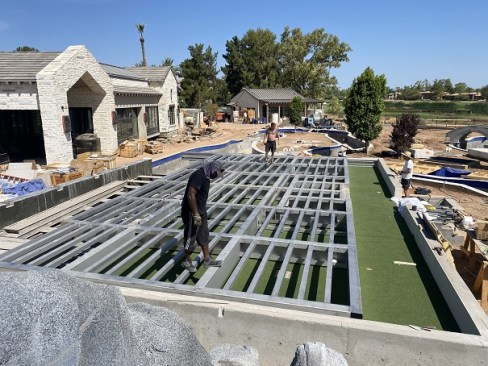 The movable floor during installation, with the artificial turf pad below.