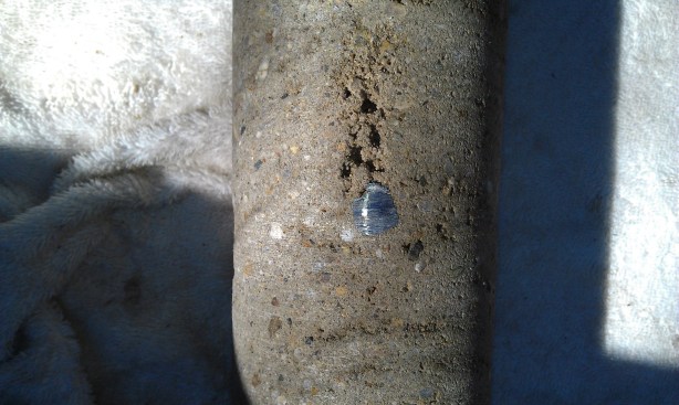 These photos show shadowing, in which shotcrete fails to properly
compact behind the rebar. Here the concrete is not monolithic in the
space behind the steel.