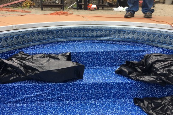 Weighing down steps, benches and other special features can help secure them in place while the liner is stretched in place.